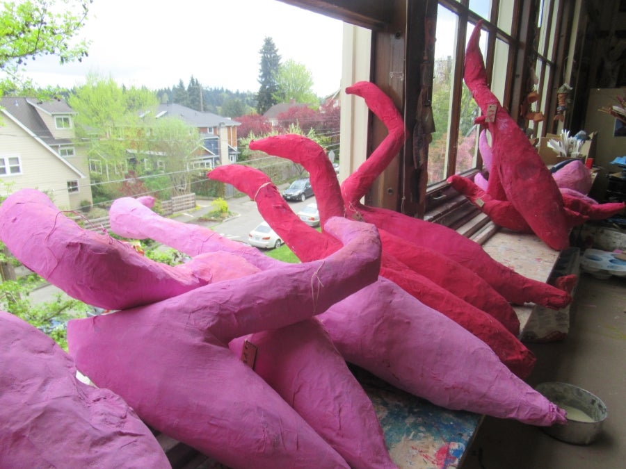 Paper Mache Flamingos looking out the window
